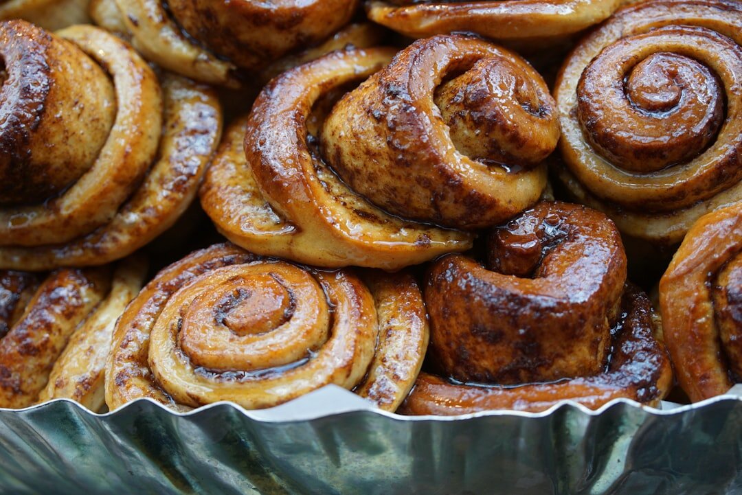 Fresh baked Czech buchty pastries on a wire rack dusted with powdered sugar