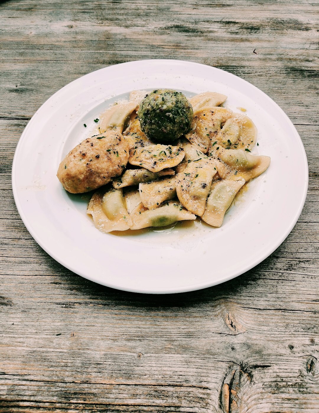 Traditional Czech svíčková with bread dumplings and cream sauce on a rustic wooden table