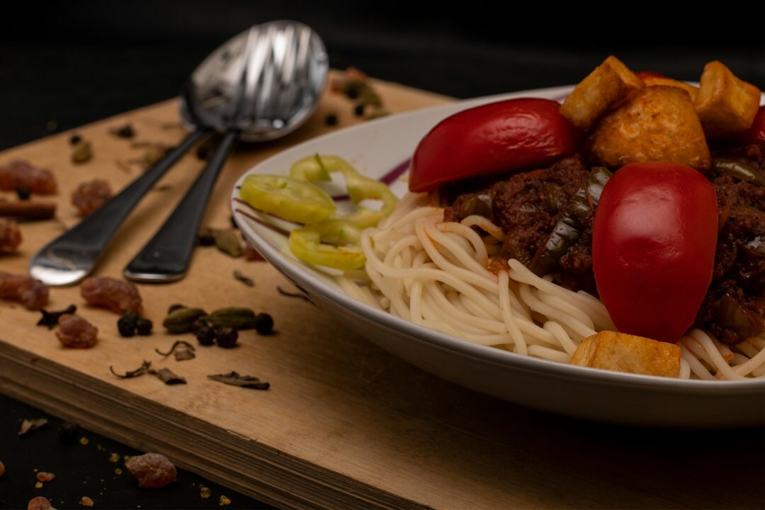 Bowl of Czech beef goulash with a slice of bread dumpling on a wooden table