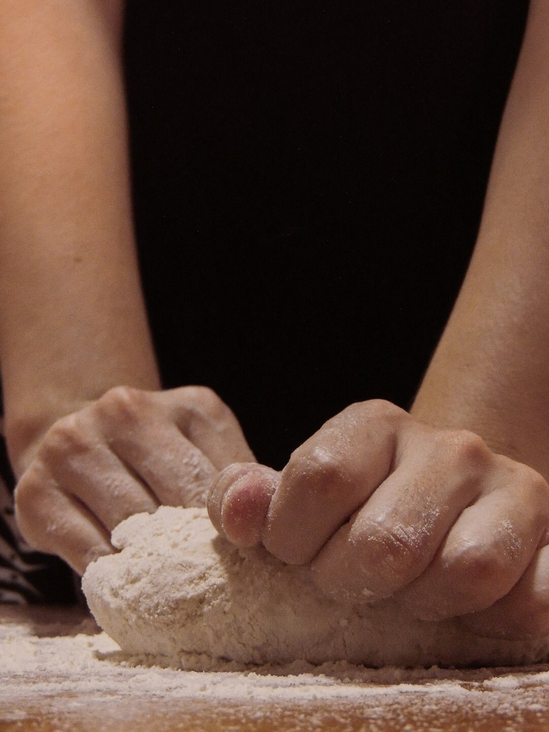 rolling out pizza dough